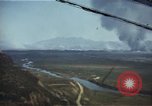 Image of burning village Korea, 1950, second 1 stock footage video 65675041558