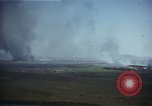 Image of burning village Korea, 1950, second 10 stock footage video 65675041558