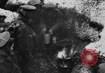 Image of British soldiers sharing Christmas pudding in trenches France, 1916, second 32 stock footage video 65675042463