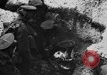 Image of British soldiers sharing Christmas pudding in trenches France, 1916, second 33 stock footage video 65675042463