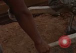 Image of pouring cement Thailand, 1966, second 55 stock footage video 65675042841