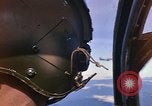 Image of A 1E Skyraider aircraft fire rockets at enemy ground target Southeast Asia, 1966, second 3 stock footage video 65675042960