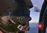 Image of A 1E Skyraider aircraft fire rockets at enemy ground target Southeast Asia, 1966, second 17 stock footage video 65675042960
