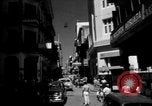 Image of Narrow crowded commercial street Puerto Rico, 1950, second 1 stock footage video 65675043413