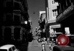 Image of Narrow crowded commercial street Puerto Rico, 1950, second 10 stock footage video 65675043413