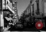 Image of Narrow crowded commercial street Puerto Rico, 1950, second 15 stock footage video 65675043413