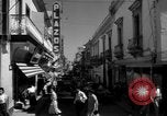 Image of Narrow crowded commercial street Puerto Rico, 1950, second 22 stock footage video 65675043413
