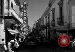 Image of Narrow crowded commercial street Puerto Rico, 1950, second 24 stock footage video 65675043413