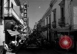 Image of Narrow crowded commercial street Puerto Rico, 1950, second 25 stock footage video 65675043413