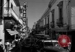 Image of Narrow crowded commercial street Puerto Rico, 1950, second 32 stock footage video 65675043413