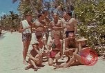 Image of people at beach Pacific Theater, 1945, second 15 stock footage video 65675046444