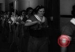 Standbild lange Schlange von uniformierten Zimmermädchen erhalten ihre Reinigungsgeräte United States USA, 1945, aus Sekunde 11 historischem Filmmaterial Videoclip 65675046827