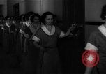 Standbild lange Schlange von uniformierten Zimmermädchen erhalten ihre Reinigungsgeräte United States USA, 1945, aus Sekunde 15 historischem Filmmaterial Videoclip 65675046827