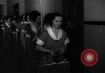 Standbild lange Schlange von uniformierten Zimmermädchen erhalten ihre Reinigungsgeräte United States USA, 1945, aus Sekunde 16 historischem Filmmaterial Videoclip 65675046827