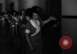 Standbild lange Schlange von uniformierten Zimmermädchen erhalten ihre Reinigungsgeräte United States USA, 1945, aus Sekunde 19 historischem Filmmaterial Videoclip 65675046827