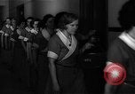 Standbild lange Schlange von uniformierten Zimmermädchen erhalten ihre Reinigungsgeräte United States USA, 1945, aus Sekunde 22 historischem Filmmaterial Videoclip 65675046827