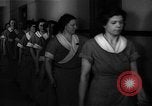 Standbild lange Schlange von uniformierten Zimmermädchen erhalten ihre Reinigungsgeräte United States USA, 1945, aus Sekunde 24 historischem Filmmaterial Videoclip 65675046827