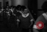 Standbild lange Schlange von uniformierten Zimmermädchen erhalten ihre Reinigungsgeräte United States USA, 1945, aus Sekunde 27 historischem Filmmaterial Videoclip 65675046827