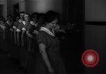 Standbild lange Schlange von uniformierten Zimmermädchen erhalten ihre Reinigungsgeräte United States USA, 1945, aus Sekunde 29 historischem Filmmaterial Videoclip 65675046827