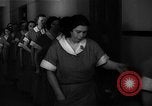 Standbild lange Schlange von uniformierten Zimmermädchen erhalten ihre Reinigungsgeräte United States USA, 1945, aus Sekunde 32 historischem Filmmaterial Videoclip 65675046827