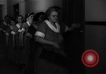 Standbild lange Schlange von uniformierten Zimmermädchen erhalten ihre Reinigungsgeräte United States USA, 1945, aus Sekunde 38 historischem Filmmaterial Videoclip 65675046827