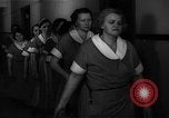 Standbild lange Schlange von uniformierten Zimmermädchen erhalten ihre Reinigungsgeräte United States USA, 1945, aus Sekunde 39 historischem Filmmaterial Videoclip 65675046827
