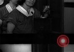 Standbild lange Schlange von uniformierten Zimmermädchen erhalten ihre Reinigungsgeräte United States USA, 1945, aus Sekunde 44 historischem Filmmaterial Videoclip 65675046827