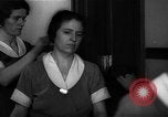 Standbild lange Schlange von uniformierten Zimmermädchen erhalten ihre Reinigungsgeräte United States USA, 1945, aus Sekunde 47 historischem Filmmaterial Videoclip 65675046827