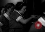 Standbild lange Schlange von uniformierten Zimmermädchen erhalten ihre Reinigungsgeräte United States USA, 1945, aus Sekunde 62 historischem Filmmaterial Videoclip 65675046827