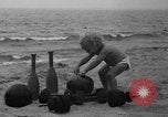 Image of boy on sandy beach United States USA, 1936, second 10 stock footage video 65675047809