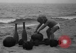 Image of boy on sandy beach United States USA, 1936, second 12 stock footage video 65675047809