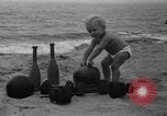 Image of boy on sandy beach United States USA, 1936, second 13 stock footage video 65675047809