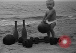 Image of boy on sandy beach United States USA, 1936, second 14 stock footage video 65675047809