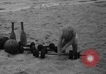 Image of boy on sandy beach United States USA, 1936, second 23 stock footage video 65675047809
