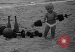 Image of boy on sandy beach United States USA, 1936, second 24 stock footage video 65675047809