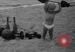 Image of boy on sandy beach United States USA, 1936, second 25 stock footage video 65675047809
