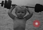 Image of boy on sandy beach United States USA, 1936, second 28 stock footage video 65675047809