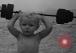 Image of boy on sandy beach United States USA, 1936, second 29 stock footage video 65675047809