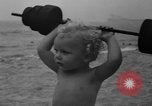 Image of boy on sandy beach United States USA, 1936, second 30 stock footage video 65675047809