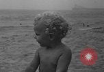Image of boy on sandy beach United States USA, 1936, second 31 stock footage video 65675047809