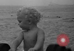 Image of boy on sandy beach United States USA, 1936, second 32 stock footage video 65675047809