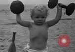 Image of boy on sandy beach United States USA, 1936, second 38 stock footage video 65675047809