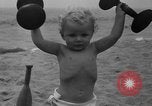 Image of boy on sandy beach United States USA, 1936, second 39 stock footage video 65675047809