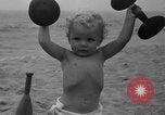 Image of boy on sandy beach United States USA, 1936, second 40 stock footage video 65675047809