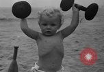Image of boy on sandy beach United States USA, 1936, second 41 stock footage video 65675047809