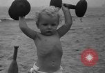 Image of boy on sandy beach United States USA, 1936, second 42 stock footage video 65675047809
