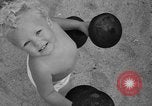 Image of boy on sandy beach United States USA, 1936, second 44 stock footage video 65675047809