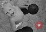 Image of boy on sandy beach United States USA, 1936, second 45 stock footage video 65675047809