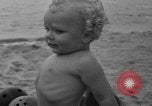 Image of boy on sandy beach United States USA, 1936, second 46 stock footage video 65675047809
