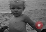 Image of boy on sandy beach United States USA, 1936, second 47 stock footage video 65675047809